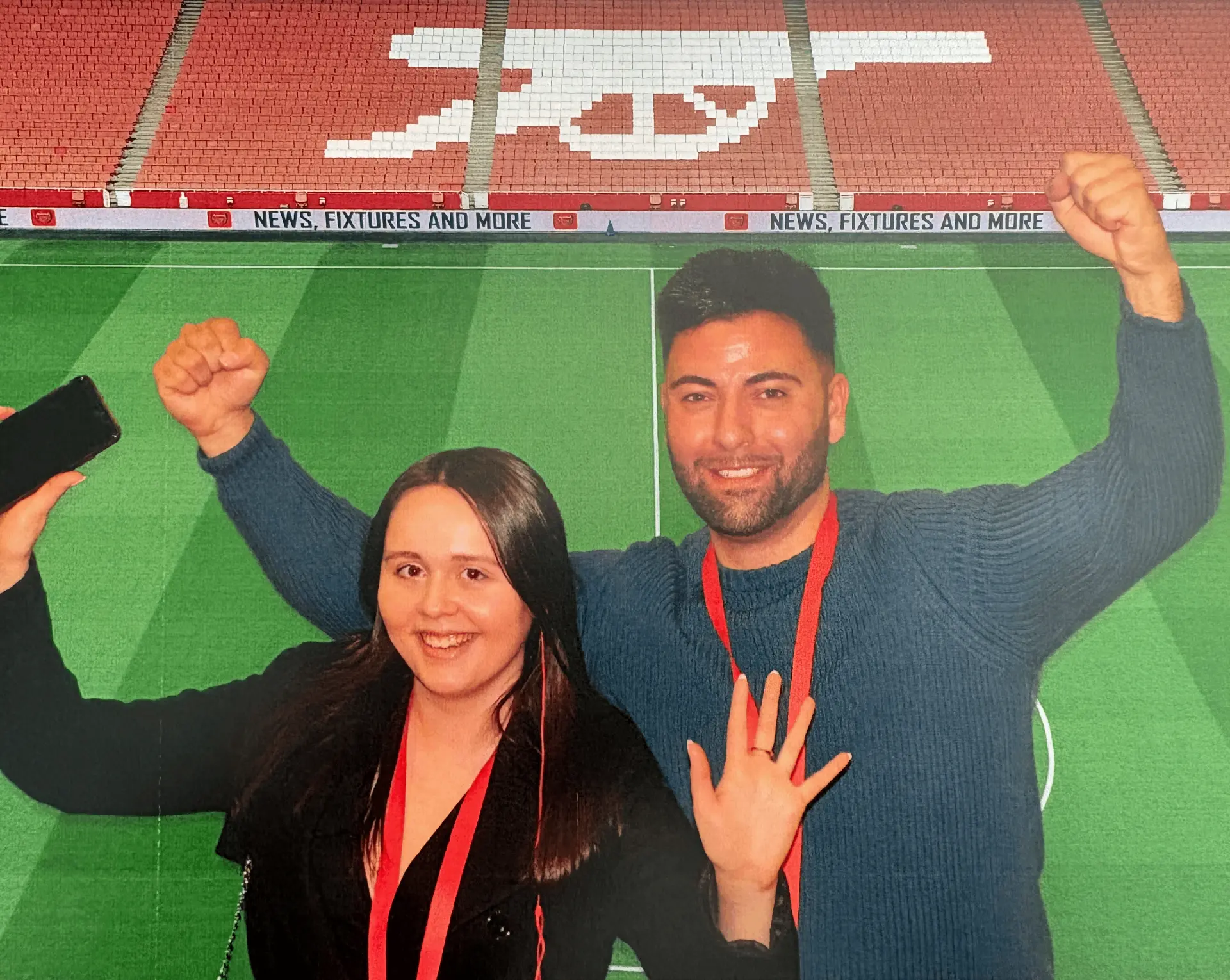 Adem and Fran celebrating at a football stadium