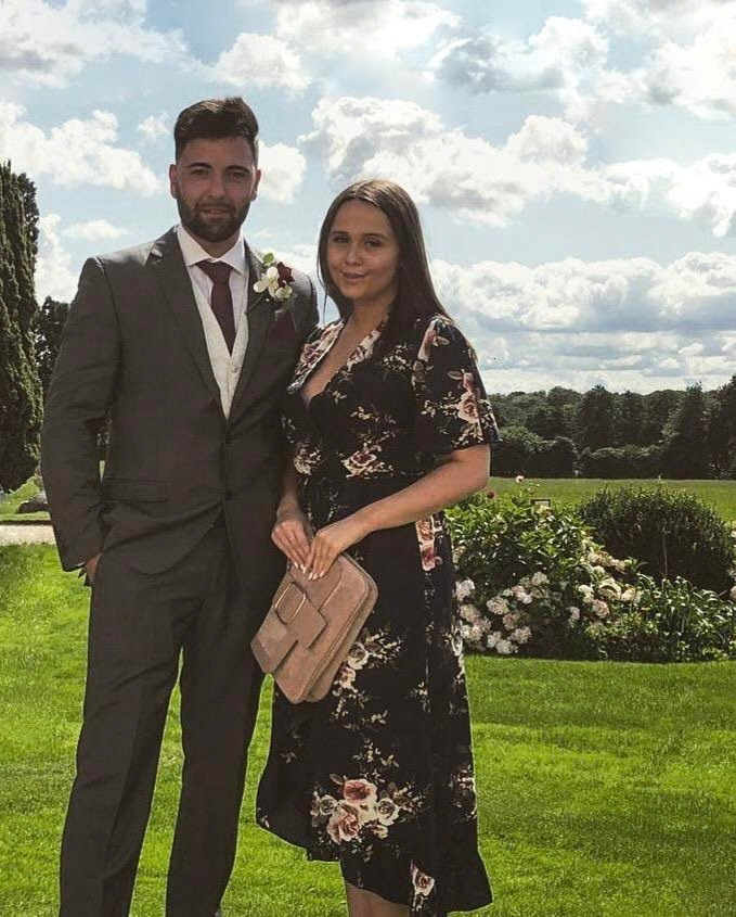 Adem and Fran dressed up at a wedding